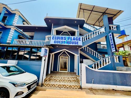a blue house with a car parked in front of it at FabHotel Elvin's Place in Calangute