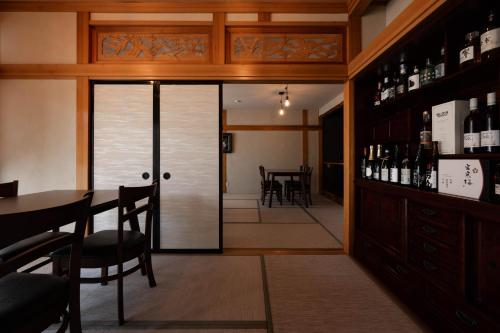 a wine tasting room with a table and glass doors at 金木犀 in Kesennuma