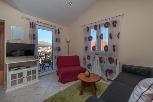 a living room with a couch and a red chair at Villa Bakica in Trogir