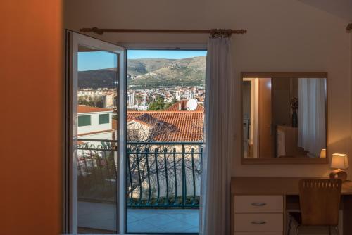 a room with a balcony with a view of a city at Villa Bakica in Trogir