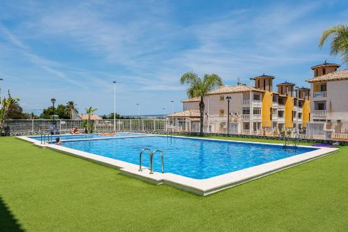 a large swimming pool in front of a building at Playa del Pinet Apartment in La Marina