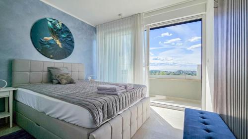 a bedroom with a bed and a large window at Sea House 1 in Novigrad Istria