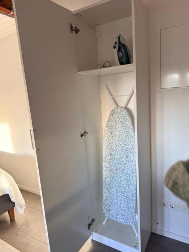 a mirror in a white closet with a window at Kinnekulle bed & breakfast in Källby