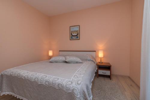 a bedroom with a bed with two pillows on it at Villa Bakica in Trogir