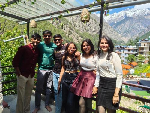 a group of people posing for a picture in front of a mountain at Kasolview Homestay and Peace Inn Cafe in Kasol