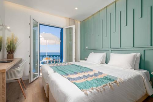 a bedroom with a bed and a desk and a window at Apanemo Seaside in Batsi