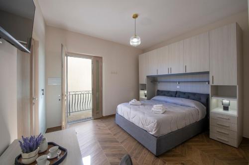 a bedroom with a large bed and a balcony at L'Incanto dei Monti in Agerola