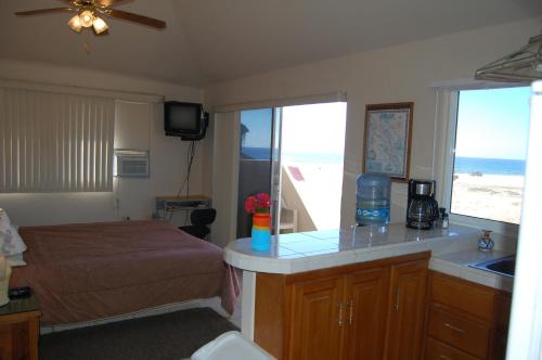 a bedroom with a bed and a view of the beach at Pescadero Palace in El Pescadero