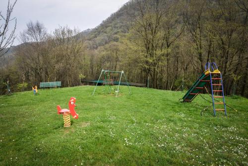 a playground with two play equipment in the grass at Bed and Breakfast La Quiete in Arcugnano