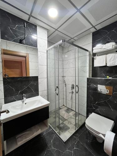 a bathroom with a shower and a sink and a toilet at Mitra Black Sea in Arhavi