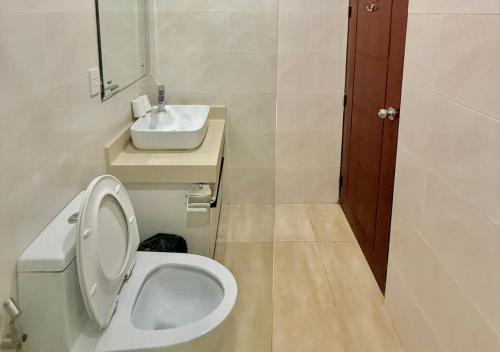 a bathroom with a toilet and a sink at Cris Inn Samal in Samal