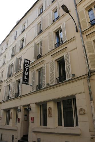 a building with a sign on the side of it at Hôtel de l'Aveyron in Paris