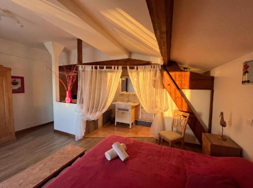 a bedroom with a red bed and a desk at Château Borie Neuve in Badens