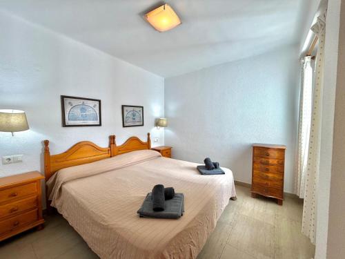 a bedroom with a bed with two towels on it at Terrasol San Francisco 5ª Planta in Torre del Mar