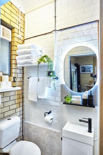 a bathroom with a white toilet and a sink at Lismore Hillside Home on Ballina Road in Lismore