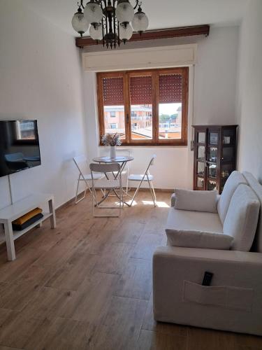 a living room with a couch and a table at Argent House Orbetello in Orbetello