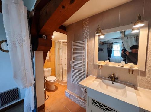 a person taking a picture of a bathroom at Château Borie Neuve in Badens