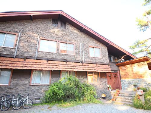 a house with bikes parked outside of it at Kunugi Relaxation with 4 modern rooms in Hakuba