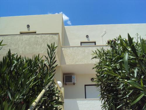 a view of the side of a building with trees at Polyrizos Hotel in Rodakino