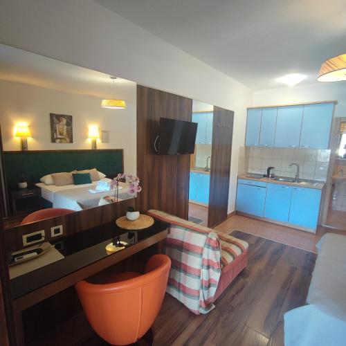 a hotel room with a bed and a living room at Apartments Villa Kresic in Neum
