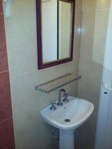 a bathroom with a white sink and a mirror at Hotel Wilton in Mar del Plata
