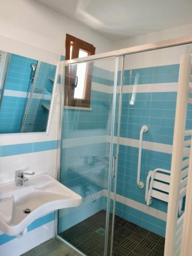 a bathroom with a sink and a shower at CASCINA PONTETTO in Asti