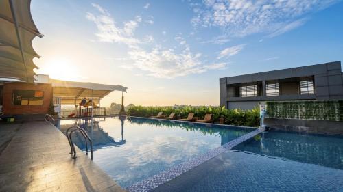 a swimming pool on the roof of a building at Grand Tjokro Premiere Bandung in Bandung