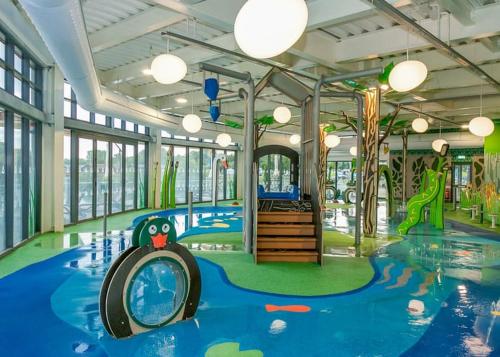 a childrens room with a pool and a playground at 26 The Meadows in Tattershall