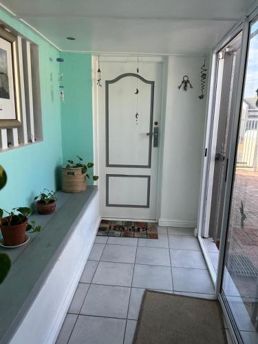 a room with a door and a tiled floor at Tiny Treasure in Klein Silwermyn