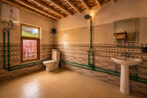 a bathroom with a toilet and a sink at Pema's Cottage by Outback Escapes in Kaza