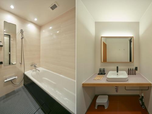 a bathroom with a tub and a sink and a mirror at A village in Fujikawaguchiko