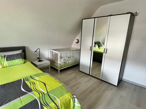 a bedroom with a bed and a large mirror at Haus Anne und Peter in Fischbach
