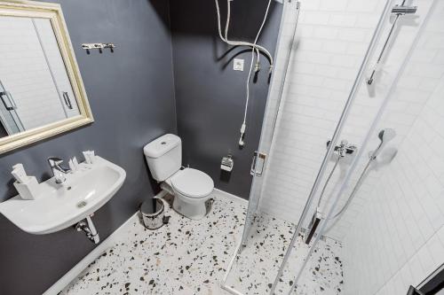 a bathroom with a shower and a toilet and a sink at Apartments in Navi in Gonio