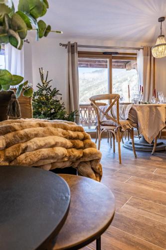 a living room with a table and a dining room at Morzine Centre Apartment 1 min from Super M in Morzine