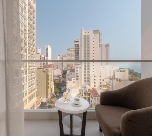 a living room with a view of a city at Sophia Central Nha Trang Hotel by HT in Nha Trang