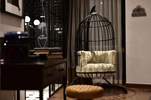 a bird cage with a chair in a room at Maxime Boutique Hotel Avenida da Liberdade in Lisbon