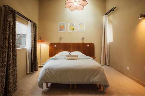 a bedroom with a large bed and a window at La Maison Générale in Besançon