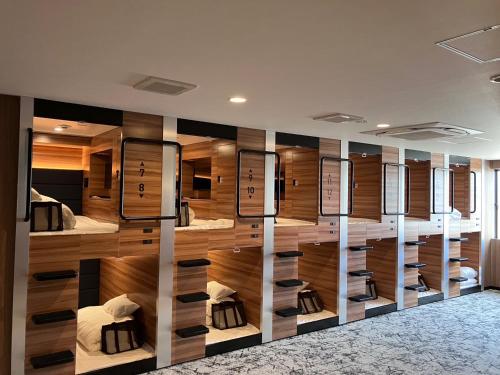 a room with a bunch of beds in it at HOTEL LiVEMAX Toyooka in Toyooka