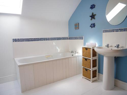a bathroom with a tub and a sink at Just Beyond Dingle in Dingle