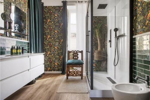 a bathroom with a tub and a sink and a chair at Alombre in Lectoure