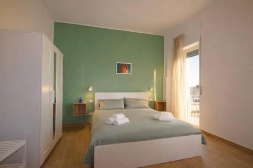 a bedroom with a bed with two towels on it at A Casa di Marco in Capua