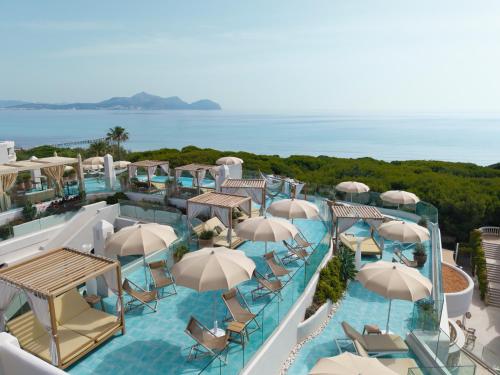 an aerial view of a resort with chairs and umbrellas at Iberostar Selection Albufera Playa All Inclusive in Playa de Muro
