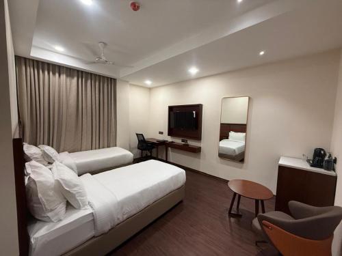 a hotel room with a bed and a mirror at HOTEL NILACHAL - 10 Mins Travel to Kamakhya Temple, Guwahati in Guwahati