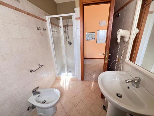 a bathroom with a sink and a toilet and a shower at Dimora le tagliate in Lucca