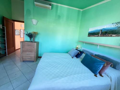 a blue bedroom with a bed and a dresser at Dimora le tagliate in Lucca