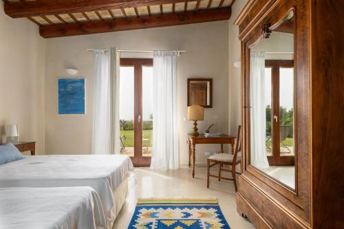 a bedroom with a bed and a large window at Villa Casale by PosarelliVillas in Bisciano
