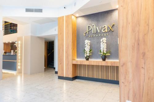 a lobby with a pharmacy sign on a wall at Pilvax Hotel Budapest in Budapest