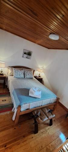 a bedroom with a bed with a wooden ceiling at Casa Clementina Guest house