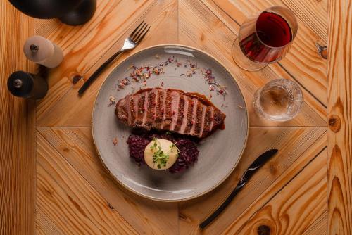 a plate of food with meat and ice cream on a table at Auenhütte in Hirschegg