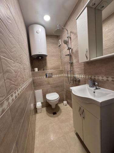 a bathroom with a toilet and a sink at Sweet Escape Varna in Varna City